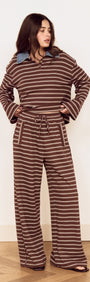 Model wearing Stripe Relaxed Drawstring Jersey Pant with vintage chocolate stripes and a relaxed fit.