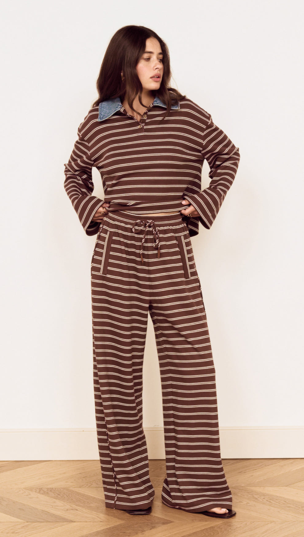 Model wearing Stripe Relaxed Drawstring Jersey Pant with vintage chocolate stripes and a relaxed fit.