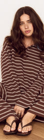Woman wearing a Constrast Collar Striped Jersey Polo Top with chocolate stripes and denim collar, sitting on the floor.