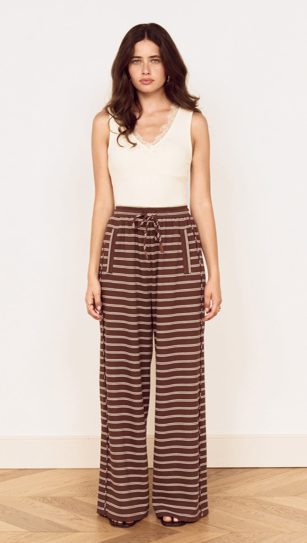Model wearing Stripe Relaxed Drawstring Jersey Pant with a soft stretch fabric and vintage chocolate stripe design.