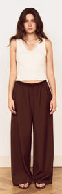 Model wearing a Cream Cotton Blend Tank with Lace Trim and brown wide-leg pants.