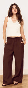 Model wearing a Cream Cotton Blend Tank with Lace Trim paired with relaxed brown pants, showcasing a stylish everyday outfit.