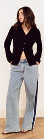 Model wearing a Black Scallop Edge Pointelle Cardigan paired with wide-leg jeans, showcasing a stylish casual look.