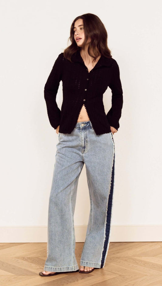 Model wearing a Black Scallop Edge Pointelle Cardigan paired with wide-leg jeans, showcasing a stylish casual look.