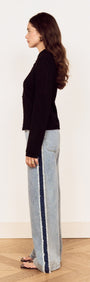 Model showcasing the Black Scallop Edge Pointelle Cardigan paired with wide-leg jeans, highlighting its fitted silhouette.
