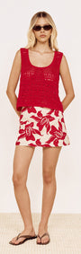 Model wearing Cotton A-Line Mini Skirt in Red Floral with a red top and sunglasses, styled on a neutral background.