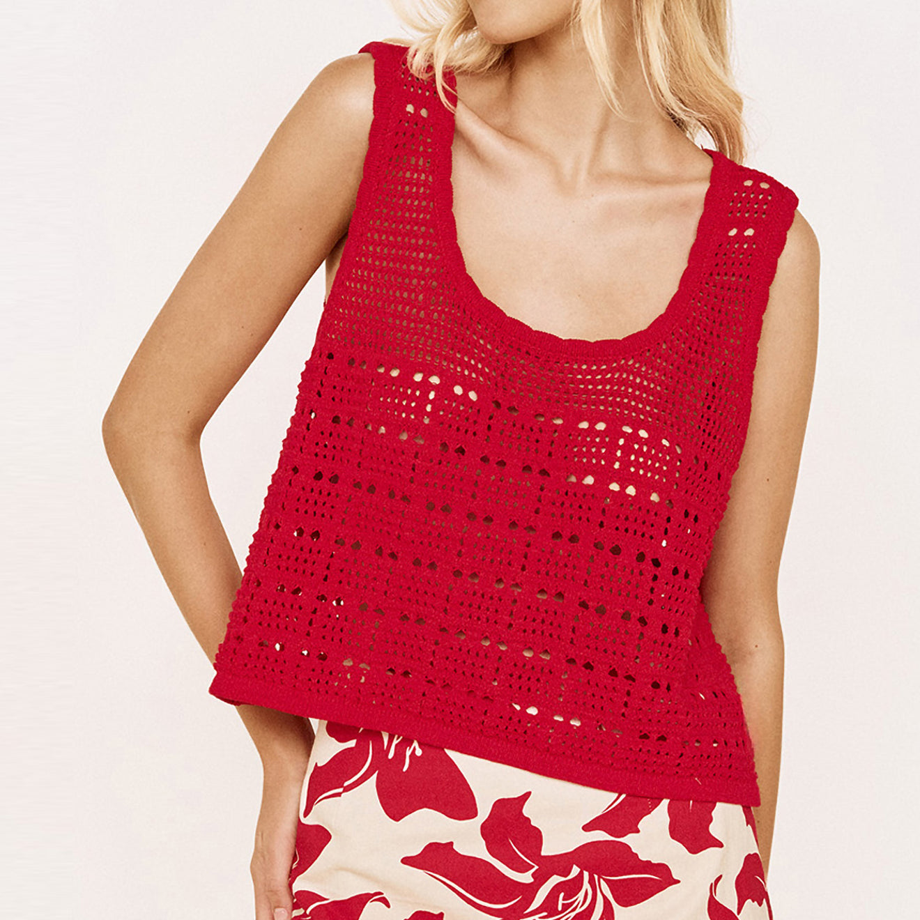 Model wearing a Round Neck Crochet Tank in Red paired with a floral skirt, showcasing a relaxed summer outfit.