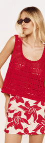 Model wearing a Round Neck Crochet Tank in Red paired with a floral skirt, showcasing a relaxed summer outfit.