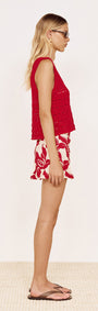 Round Neck Crochet Tank in Red worn with floral shorts, showcasing a relaxed fit and open-stitch knit design.