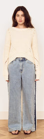 Cream Round Neck Open Knit Jumper styled with wide leg denim jeans against a neutral background.