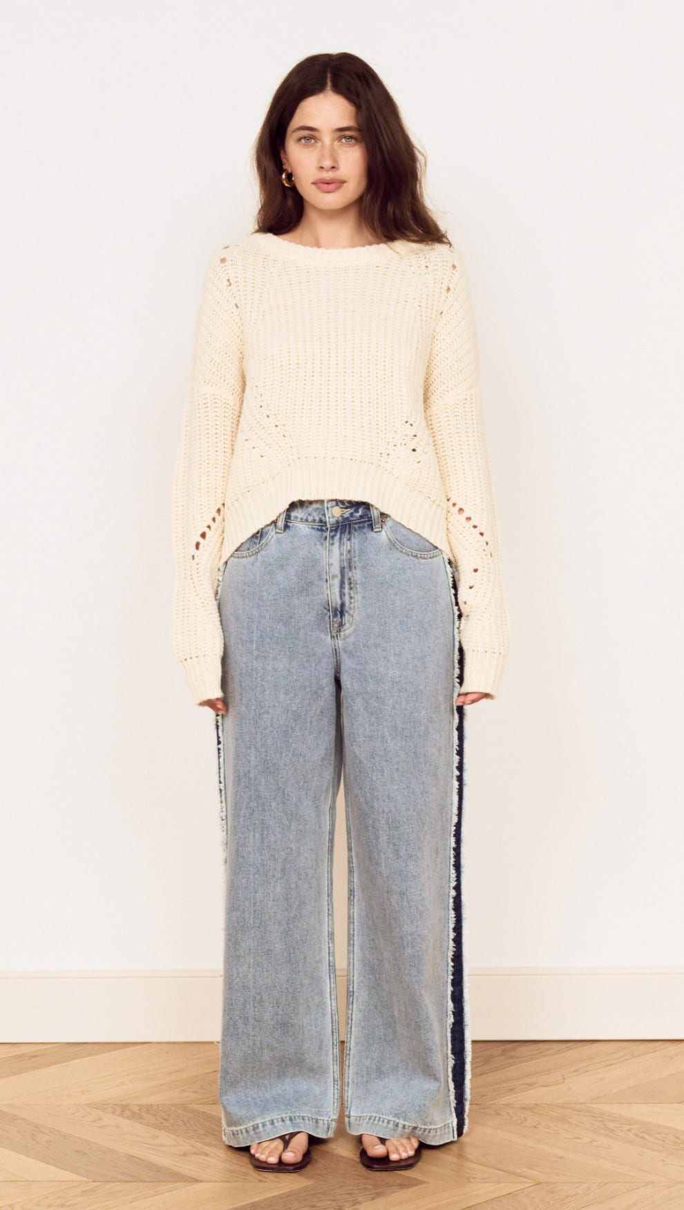 Cream Round Neck Open Knit Jumper styled with wide leg denim jeans against a neutral background.