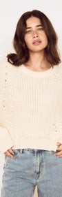 Model wearing a Cream Round Neck Open Knit Jumper with relaxed fit and oversized sleeves.
