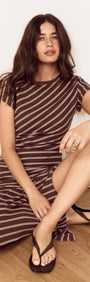 Striped Jersey Ruched Midi Dress worn by a model, featuring chocolate stripe print and flattering ruching.
