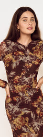 Model wearing a Brown Floral Gathered Mesh Midi Dress with long sleeves and floral print design.