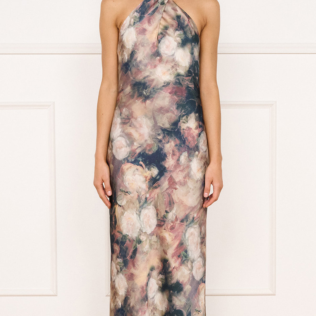 Satin Halter Neck Maxi Dress in Rose Floral worn by model, showcasing a floral design with a halter neckline and maxi silhouette.