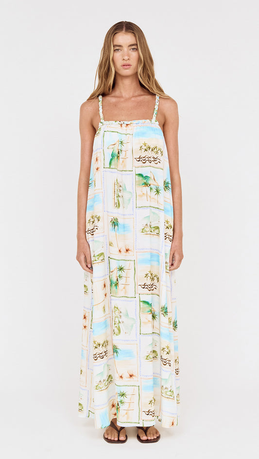 Model wearing Island Postcard Print Maxi Dress with Braided Straps featuring vibrant postcard-inspired print.