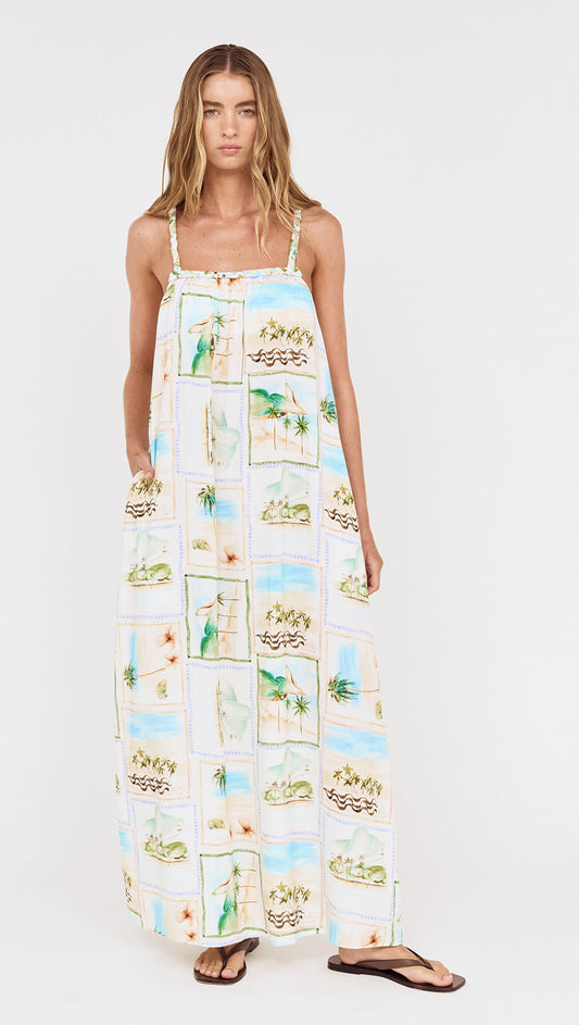 Model wearing Island Postcard Print Maxi Dress with Braided Straps featuring a postcard-inspired print and braided shoulder straps.