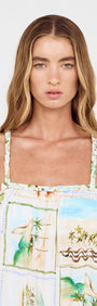 Model wearing Island Postcard Print Maxi Dress with Braided Straps, showcasing the postcard-inspired design and braided straps.
