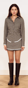 Model wearing a Contrast Hem Mini Skirt in Grey Check styled with a matching shirt and knee-high boots.