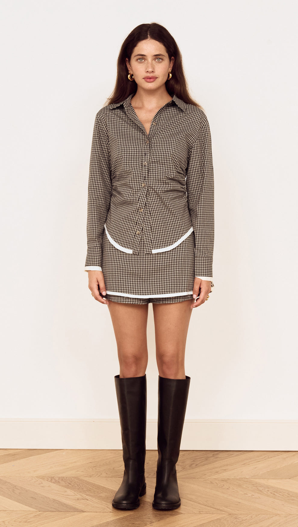 Model wearing a Contrast Hem Mini Skirt in Grey Check styled with a matching shirt and knee-high boots.