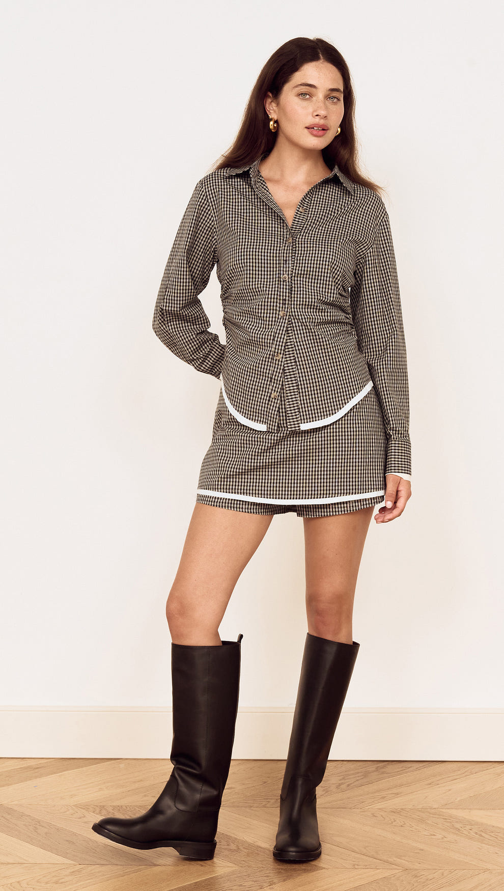 Model wearing the Contrast Hem Mini Skirt in Grey Check paired with a matching check shirt and knee-high boots.