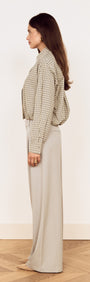 Cotton Bubble Hem Shirt in Blue Check styled with relaxed pants, showcased in a side view, highlighting its playful design.