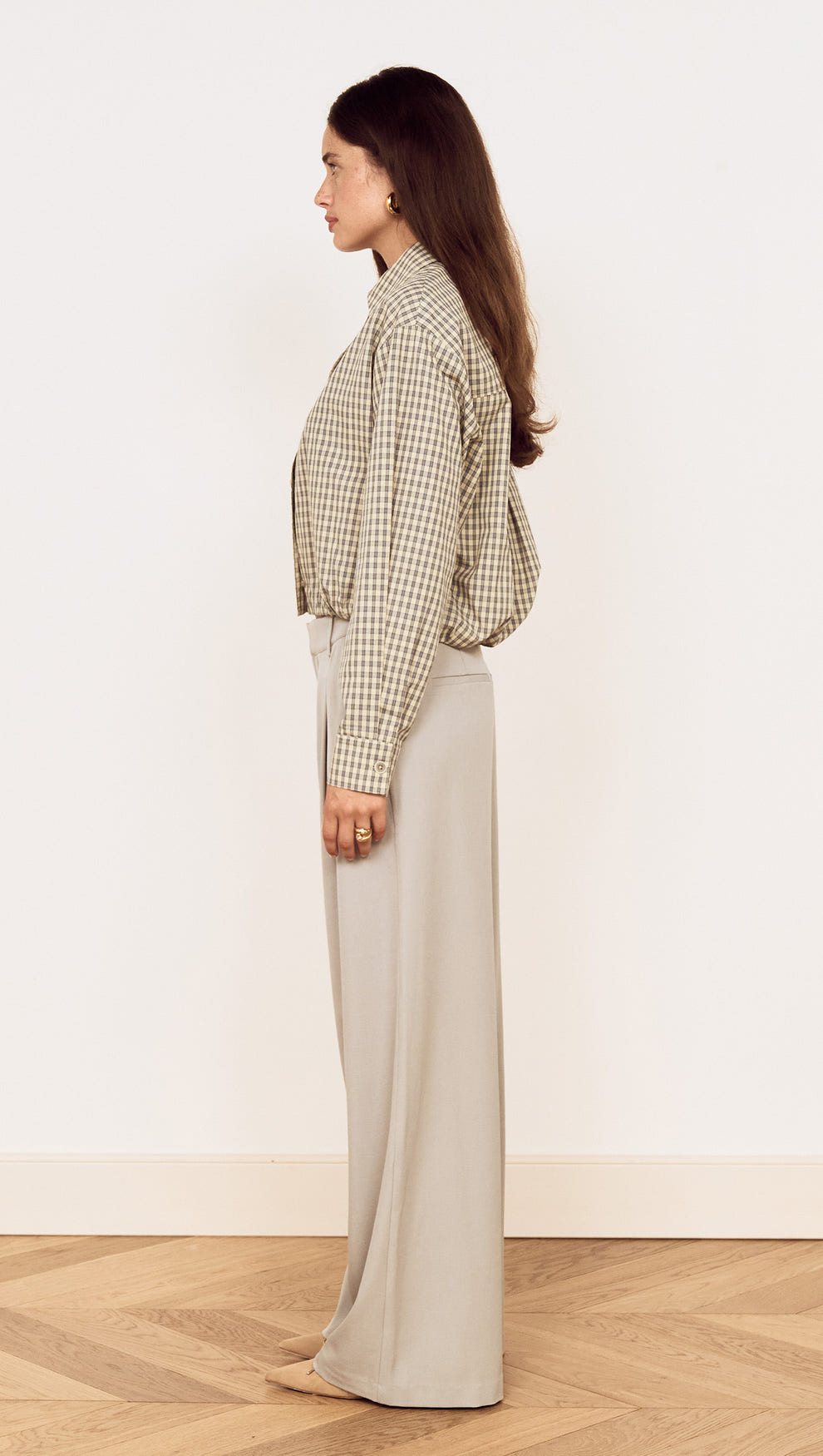 Cotton Bubble Hem Shirt in Blue Check styled with relaxed pants, showcased in a side view, highlighting its playful design.