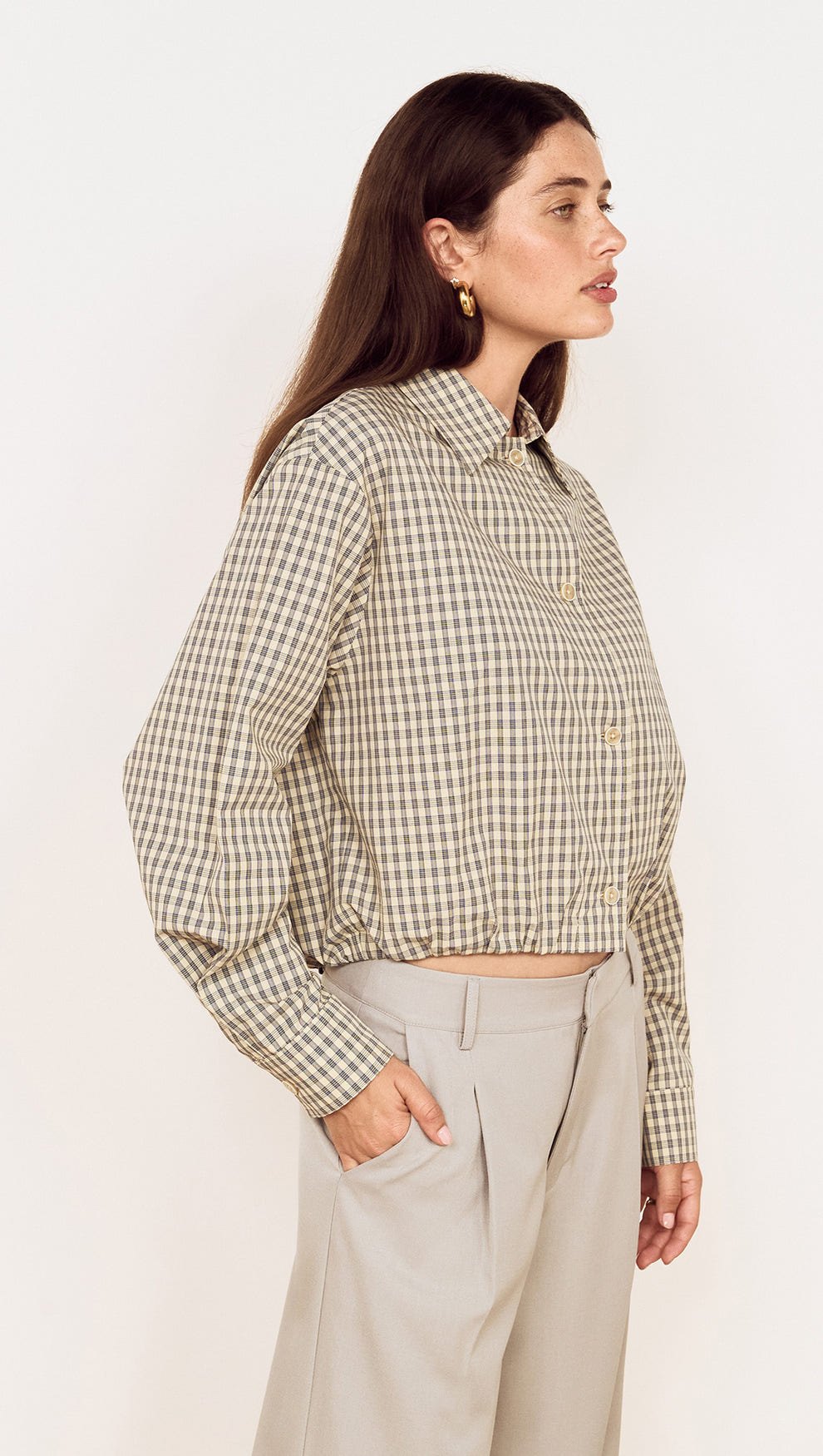Cotton Bubble Hem Shirt in Blue Check worn with tailored pants, showing a side view and gathered bubble hem design.