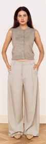 Model wearing Mid Rise Tailored Suit Pant in Grey with a grey sleeveless top, showcasing a relaxed and polished look.