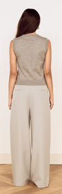 Model wearing the Round Neck Knitted Vest in Soft Grey, showcasing the back view with wide-leg trousers.