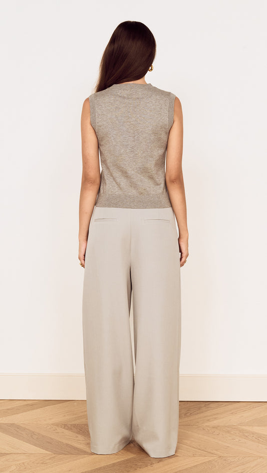 Back view of a woman wearing Mid Rise Tailored Suit Pant in Grey, paired with a sleeveless grey top.