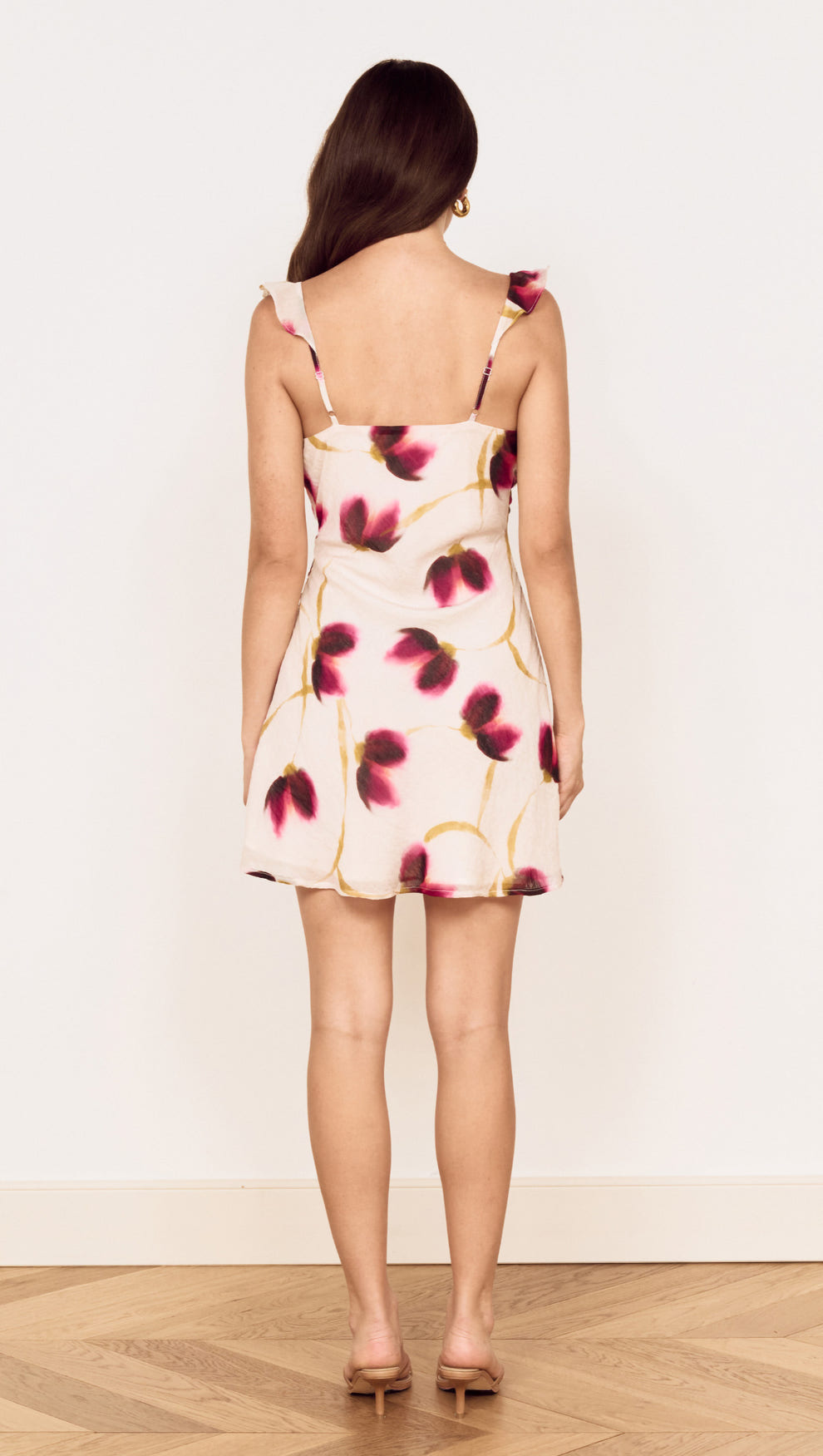 Back view of Floral Ruffle Detail Bias Mini Dress featuring floral print, ruffle detailing, and a mini skirt design.