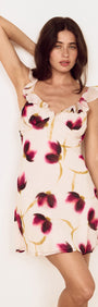 Floral Ruffle Detail Bias Mini Dress displayed on model, featuring a blurred floral print in rich berry and golden tones.