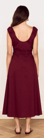 Back view of a woman wearing a Cotton Wrap Detail Midi Dress in Burgundy with ruffled sleeves and a belted waist.