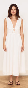 Cotton Broderie Anglaise Sleeveless Dress worn by a model, featuring a plunging V-neck and gathered skirt.