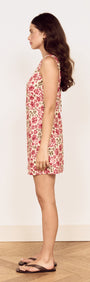 Model showcasing Vintage Floral Print Tie-Back Mini Dress in profile view against a light background.