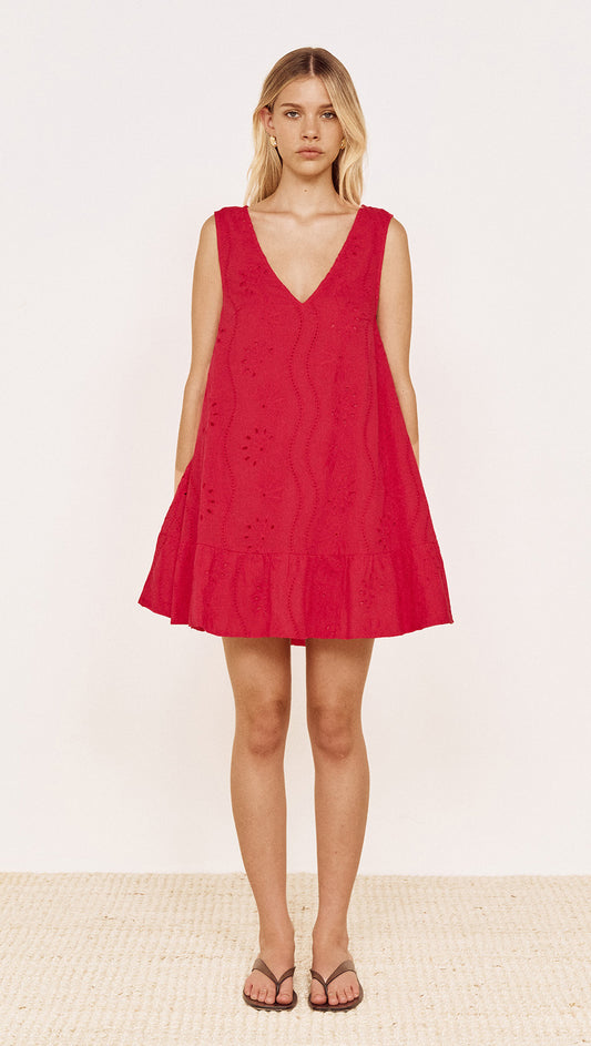 Cotton Broderie Mini Dress in Red on model, featuring V-neckline and frill hem, perfect for warm weather.