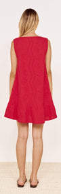 Back view of the Cotton Broderie Mini Dress in Red, showcasing its A-line silhouette and frill hem.