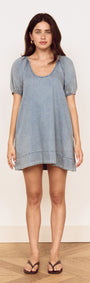 Model wearing Puff Sleeve Fluid Denim Mini Dress in soft washed denim with puff sleeves and scoop neckline.