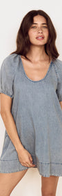 Puff Sleeve Fluid Denim Mini Dress featuring puff sleeves and a relaxed silhouette in soft washed denim.