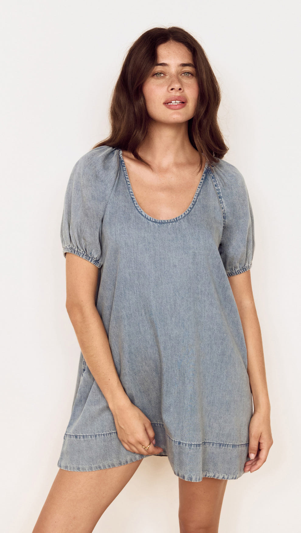 Puff Sleeve Fluid Denim Mini Dress featuring puff sleeves and a relaxed silhouette in soft washed denim.
