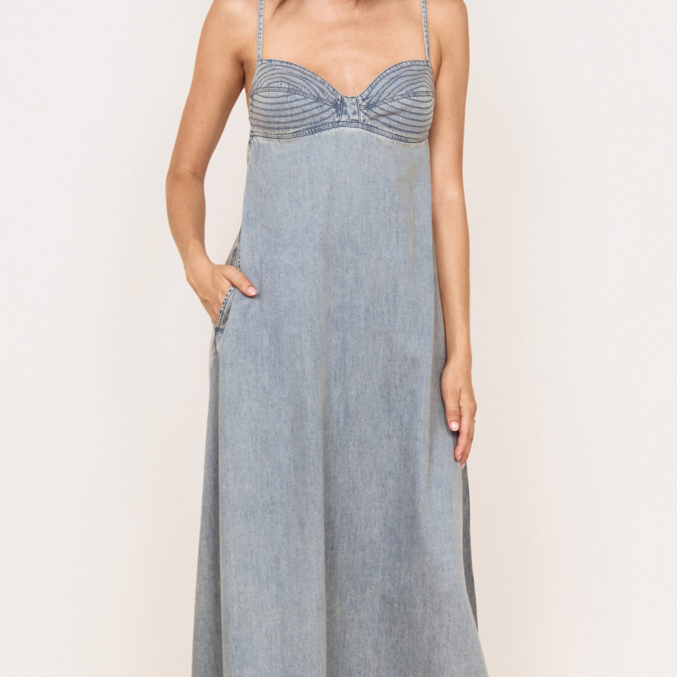 Fluid Denim Maxi Sundress in Lightwash displayed on a model with a fitted bust and flowing skirt.