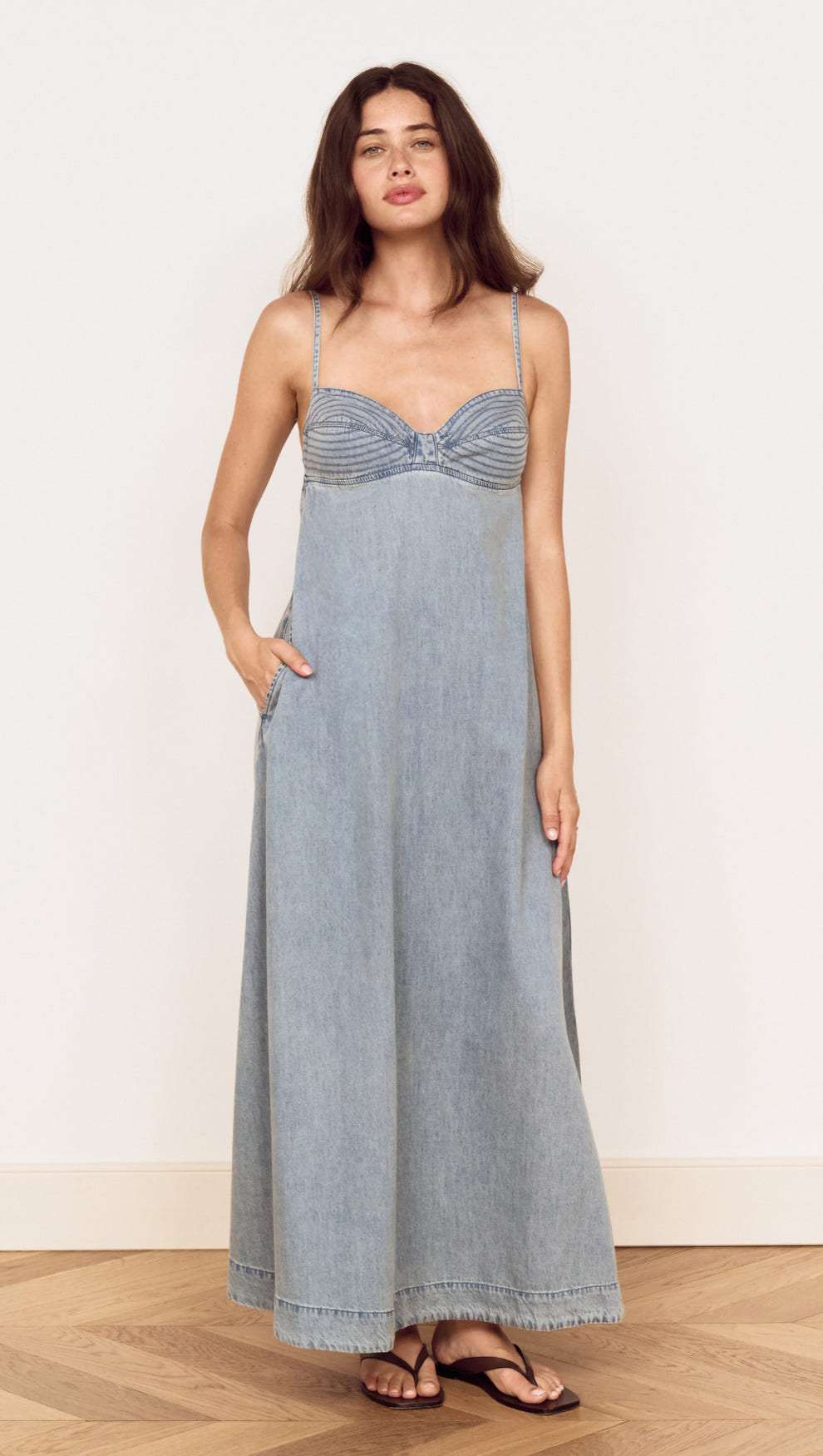 Fluid Denim Maxi Sundress in Lightwash displayed on a model with a fitted bust and flowing skirt.