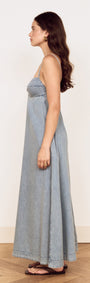 Fluid Denim Maxi Sundress in Lightwash displayed on a model, showcasing its flowing silhouette and feminine fit.