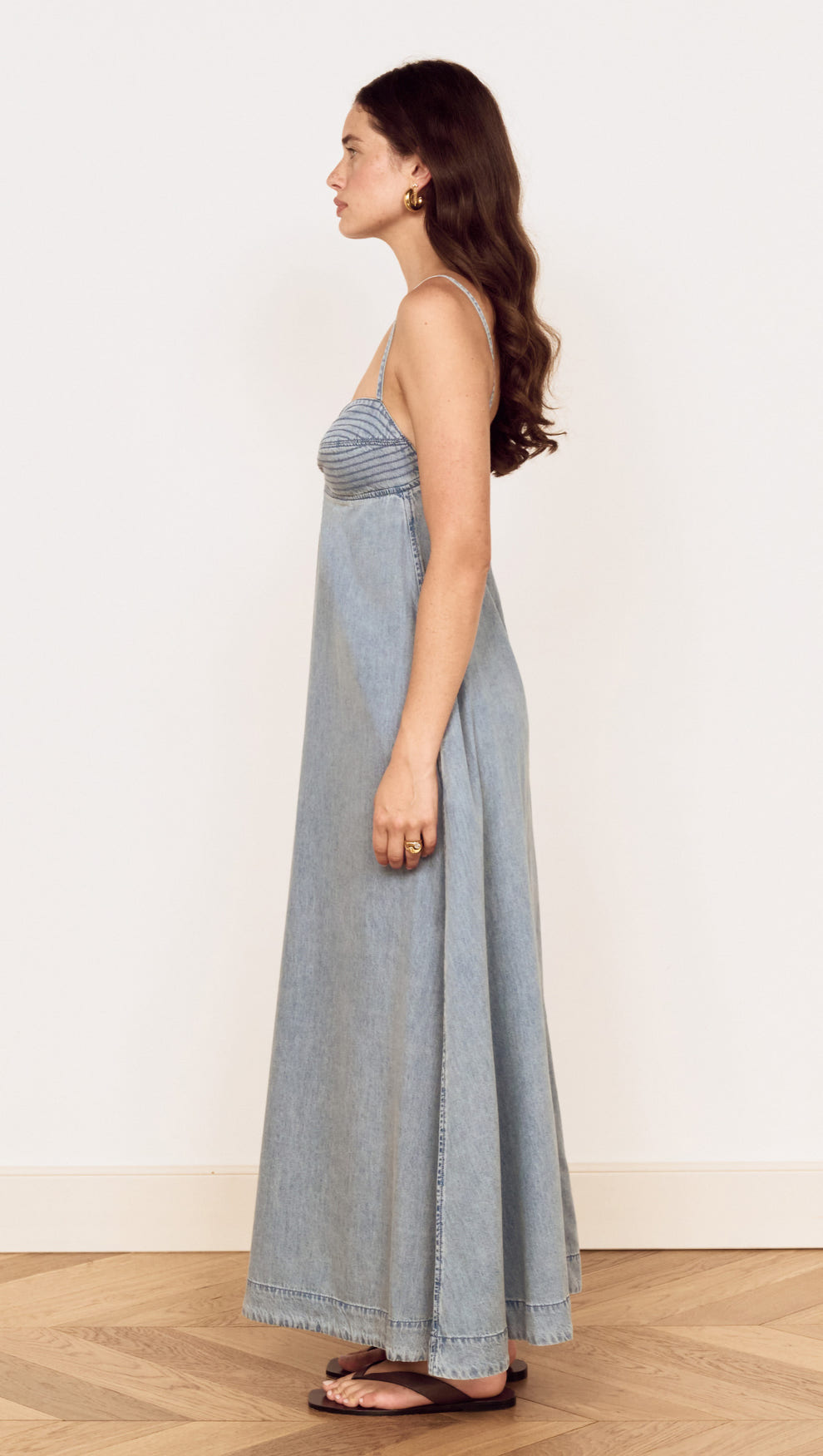 Fluid Denim Maxi Sundress in Lightwash displayed on a model, showcasing its flowing silhouette and feminine fit.
