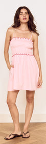 Linen Blend Mini Dress with Scallop Detail in soft pink with scalloped embroidery and adjustable straps.