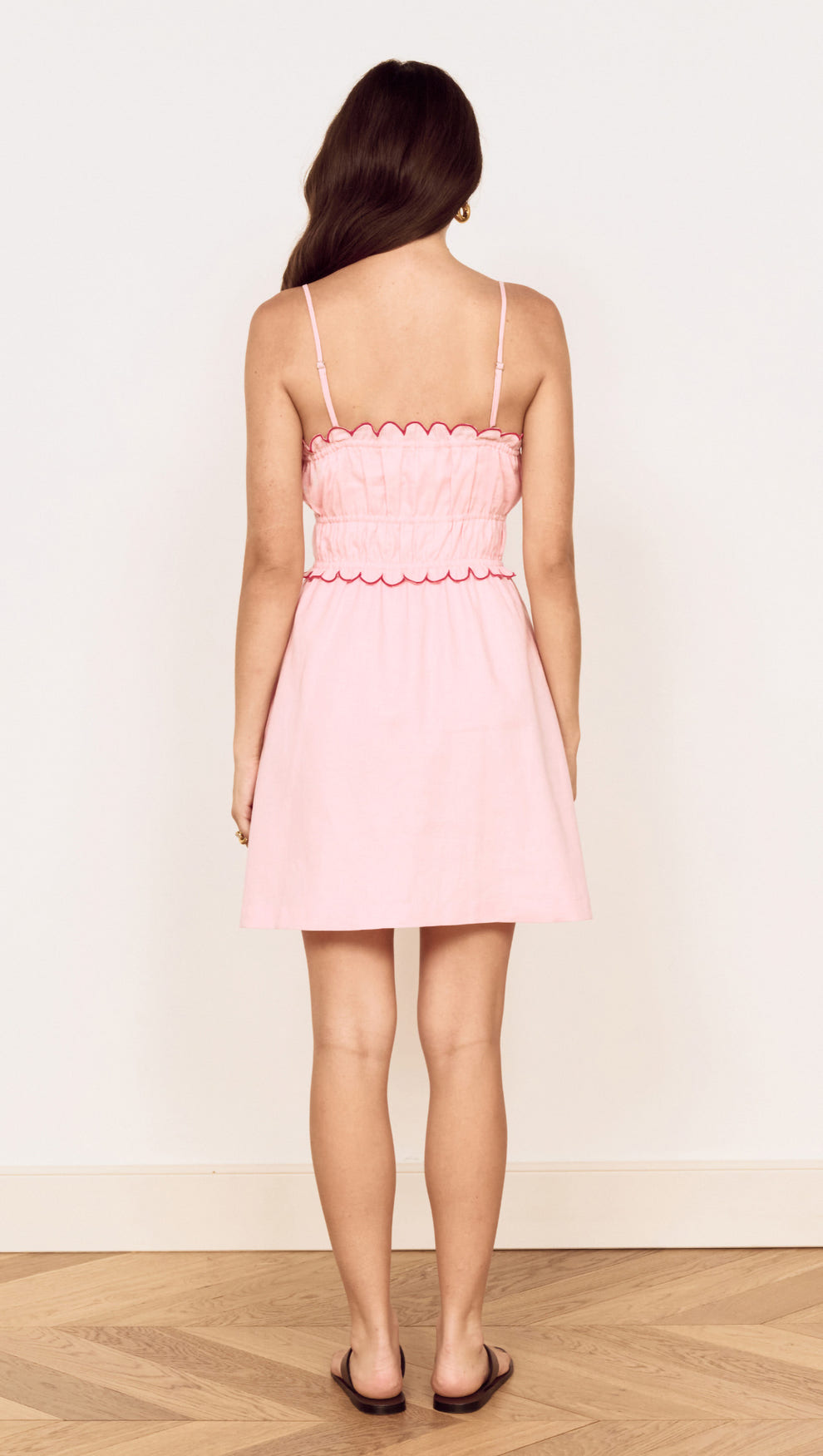 Linen Blend Mini Dress with Scallop Detail in soft pink, featuring a gathered bodice and adjustable straps.