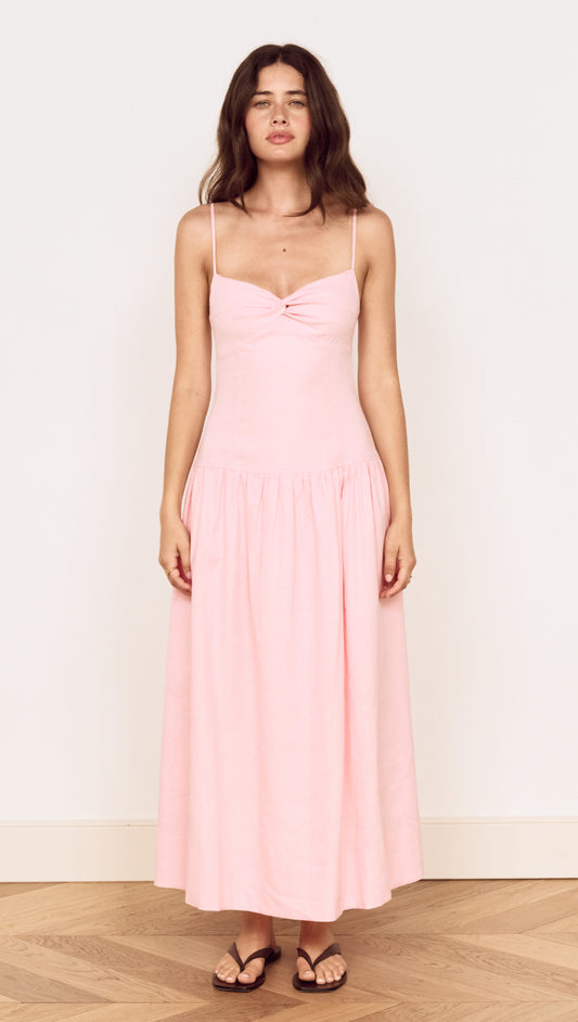 Linen Blend Midi Dress with Drop Waist displayed on a model in soft pink hue with twist-front detail and adjustable straps.