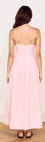 Back view of a woman wearing a Linen Blend Midi Dress with Drop Waist in soft pink, showcasing its elegant design.