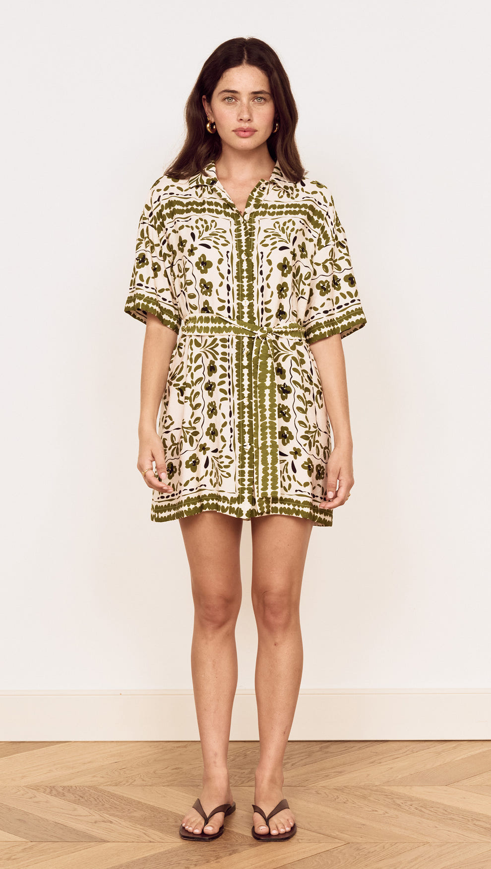 Model wearing a Scarf Print Shirt Dress in Olive with floral print and a self-tie waist belt.